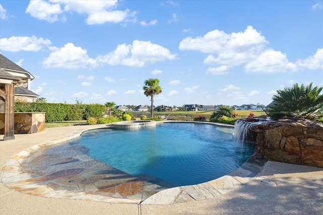 view of pool with pool water feature and an in ground hot tub