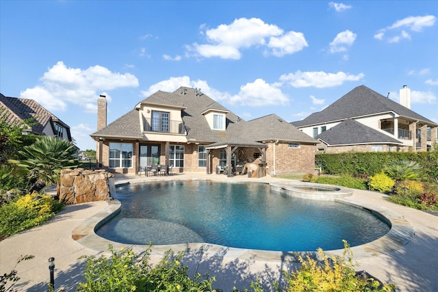 view of swimming pool with a patio area and an in ground hot tub