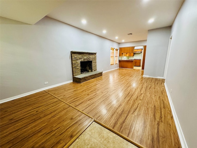 unfurnished living room featuring light hardwood / wood-style floors and a fireplace