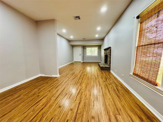 unfurnished living room featuring light hardwood / wood-style floors and a fireplace