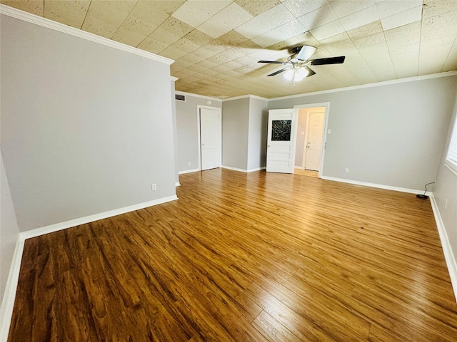 spare room with ceiling fan, wood-type flooring, and crown molding