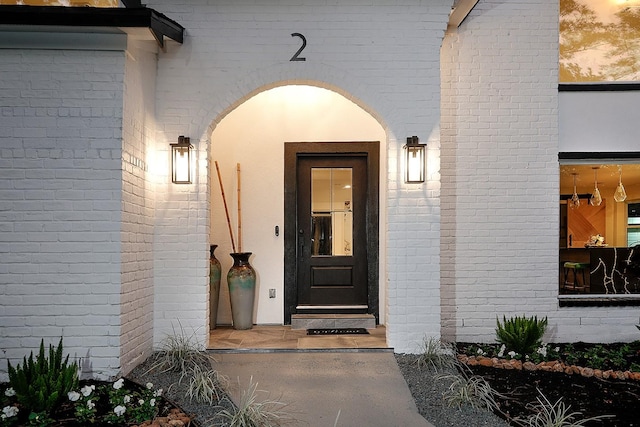 view of exterior entry at dusk