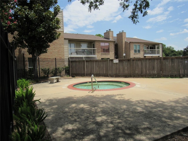 view of pool featuring a hot tub