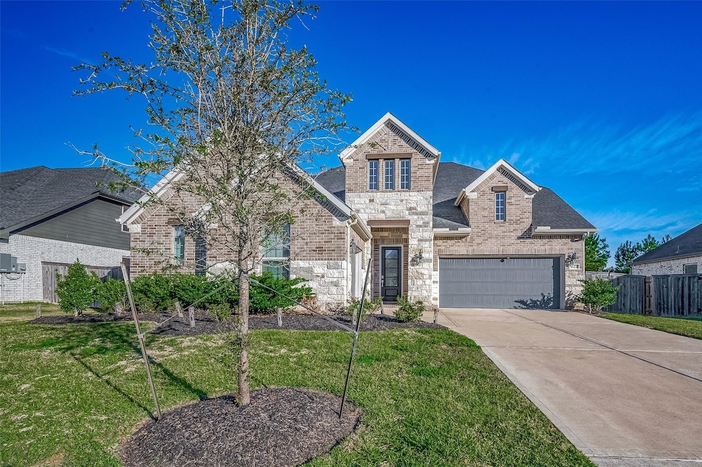 front of property featuring a garage and a front yard