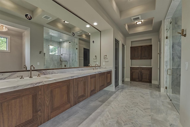 bathroom featuring tile patterned flooring, vanity, a shower with shower door, and a tray ceiling