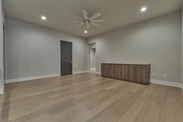 empty room featuring light wood-type flooring and ceiling fan