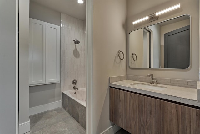 bathroom featuring tile patterned flooring, vanity, and washtub / shower combination