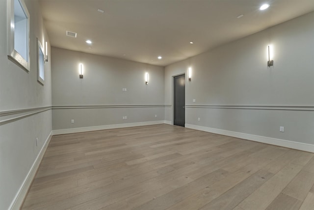 unfurnished room with light wood-type flooring