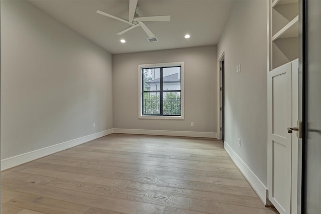 spare room featuring ceiling fan and light hardwood / wood-style flooring