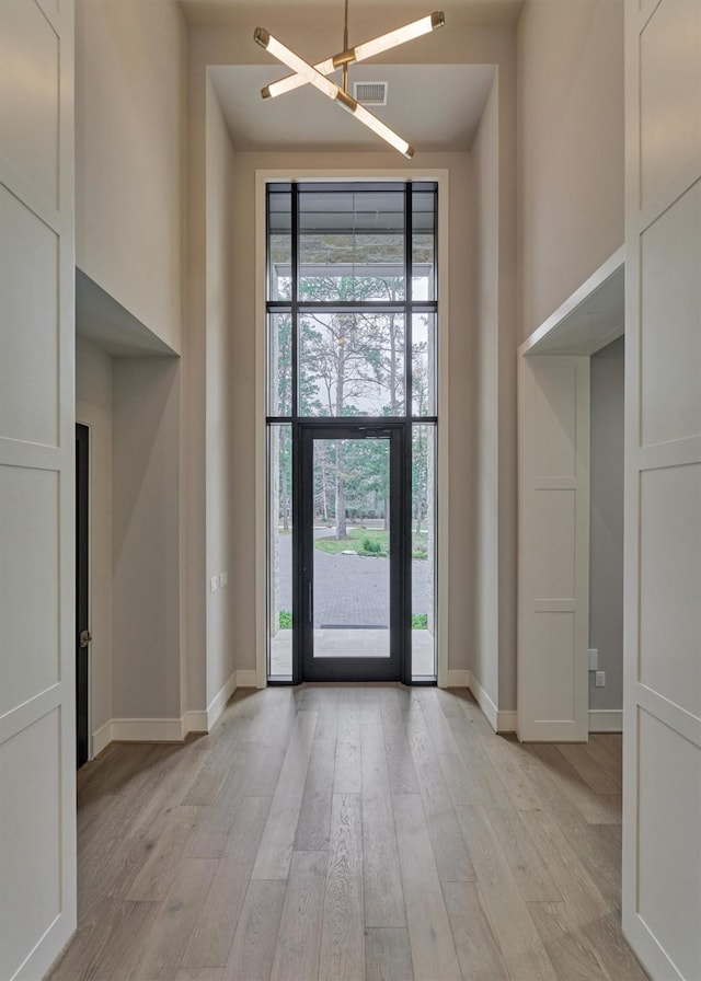 entryway with a chandelier and light hardwood / wood-style floors