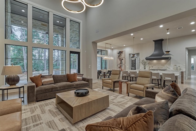 living room with a high ceiling and an inviting chandelier