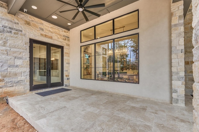 entrance to property with french doors, a patio, and ceiling fan