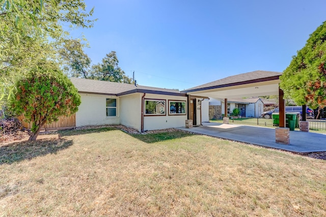 back of property featuring a patio area and a lawn