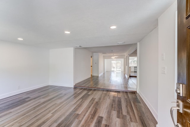 spare room with hardwood / wood-style floors and ceiling fan