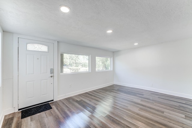 foyer featuring wood-type flooring and a textured ceiling