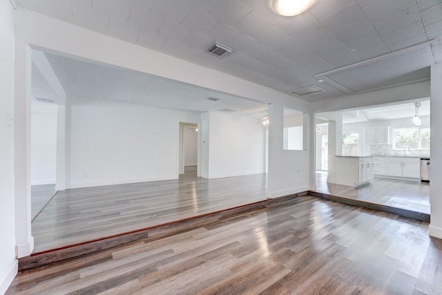 interior space with hardwood / wood-style floors and sink