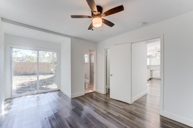 interior space with ceiling fan with notable chandelier and dark wood-type flooring