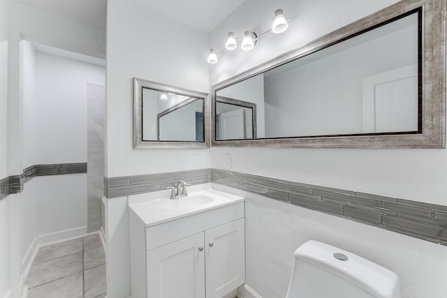 bathroom with tile patterned floors, vanity, and toilet