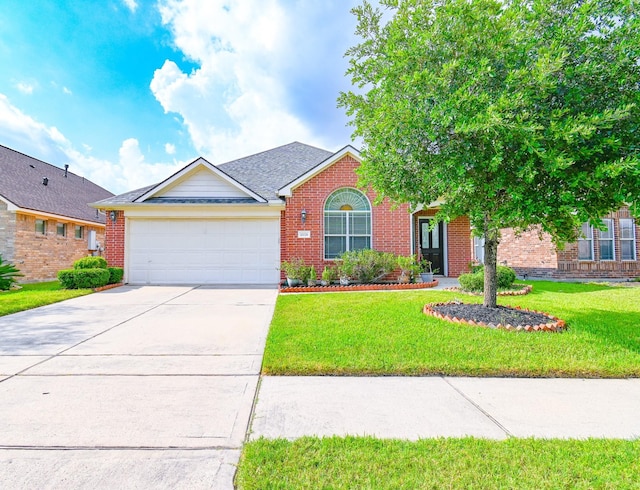 view of front of house featuring a garage and a front lawn