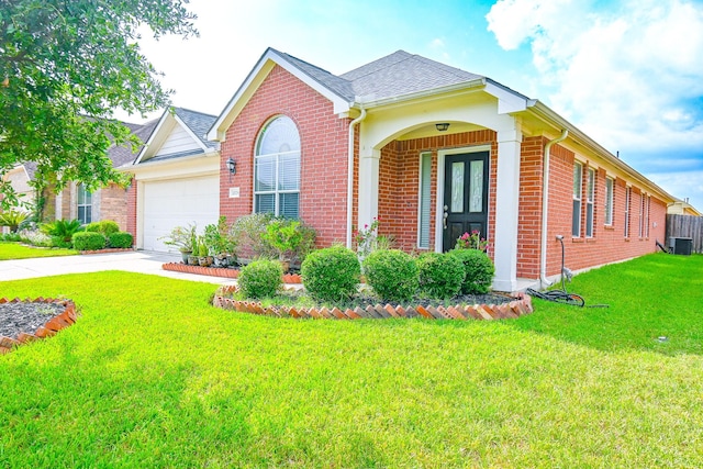 ranch-style house featuring a front yard, a garage, and cooling unit