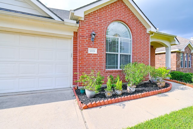 view of exterior entry with a garage