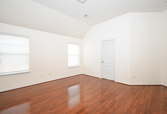 unfurnished room with wood-type flooring and vaulted ceiling