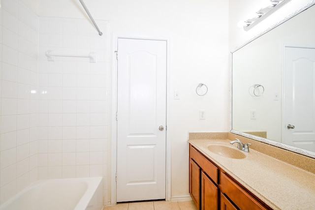 bathroom with tile patterned floors, vanity, and tiled shower / bath