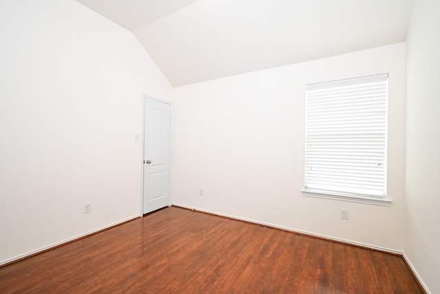 empty room featuring hardwood / wood-style floors and lofted ceiling