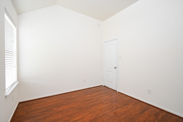 unfurnished room featuring vaulted ceiling and hardwood / wood-style flooring