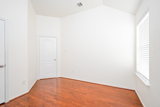 unfurnished room featuring hardwood / wood-style flooring and vaulted ceiling