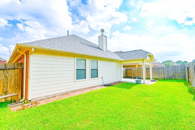 back of house with a yard