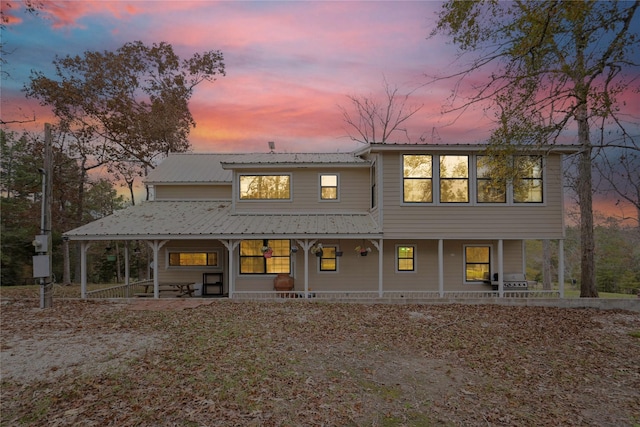 view of back house at dusk