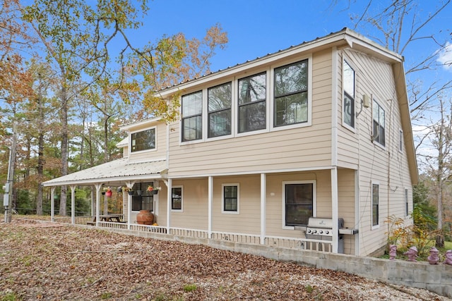 view of front of home with area for grilling and covered porch