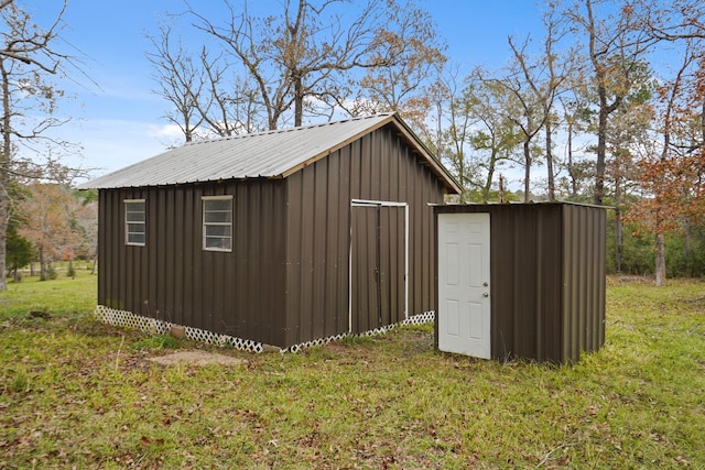 view of outdoor structure featuring a lawn