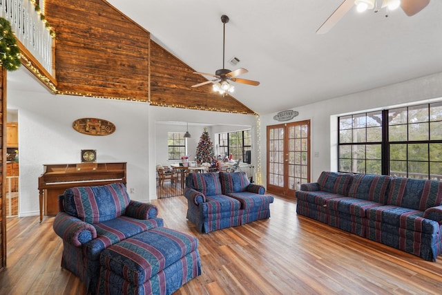 living room featuring french doors, light hardwood / wood-style floors, high vaulted ceiling, and ceiling fan