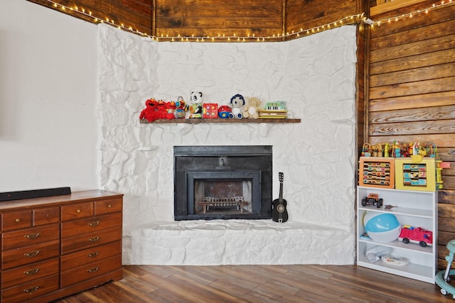 interior space with a stone fireplace and hardwood / wood-style floors