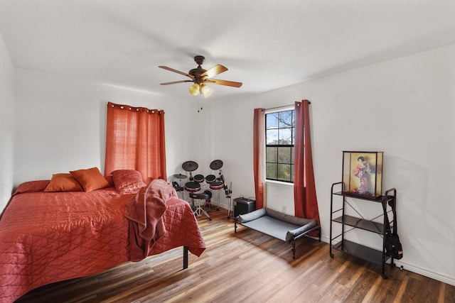 bedroom with ceiling fan and wood-type flooring