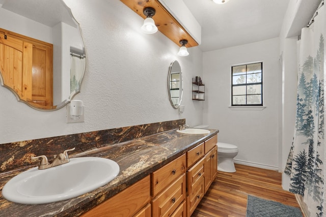 bathroom featuring hardwood / wood-style floors, vanity, and toilet