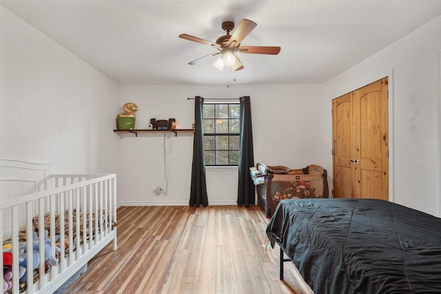 bedroom with hardwood / wood-style floors, a closet, and ceiling fan