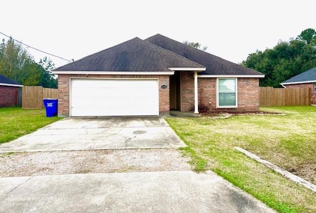 ranch-style home featuring a front yard and a garage