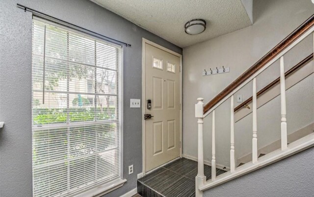 entryway featuring a textured ceiling