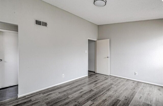 unfurnished bedroom with hardwood / wood-style flooring and a closet