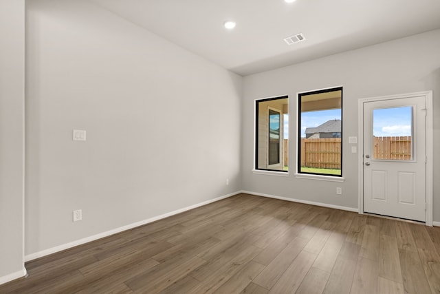 spare room with hardwood / wood-style floors