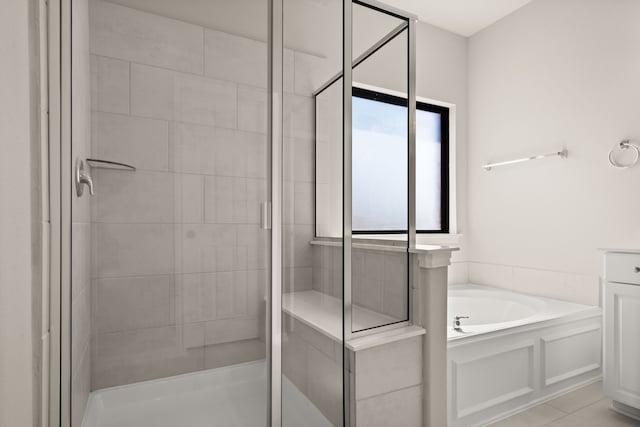 bathroom featuring separate shower and tub and tile patterned flooring