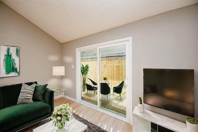 living room featuring hardwood / wood-style flooring and vaulted ceiling