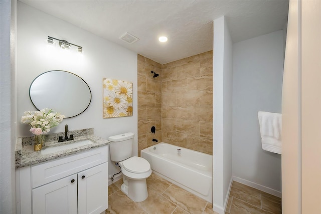 full bathroom featuring vanity, tiled shower / bath combo, and toilet