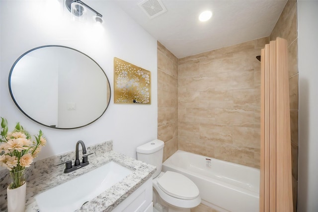 full bathroom with vanity, tiled shower / bath combo, and toilet