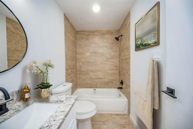 full bathroom featuring tile patterned floors, vanity, toilet, and tiled shower / bath combo