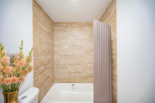 bathroom with a textured ceiling and toilet