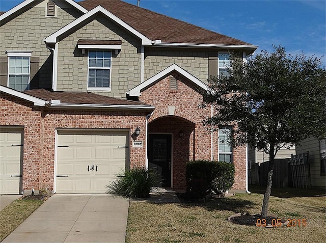 view of front of house with a garage and a front yard